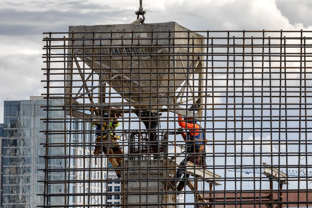 two men working on concrete construction site