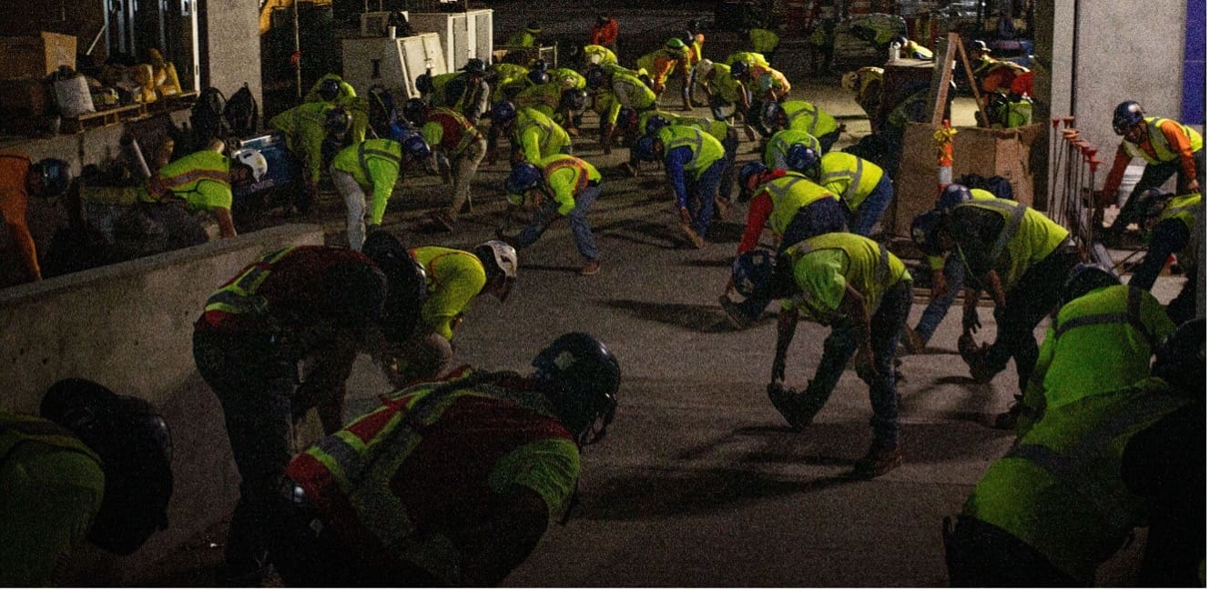 concrete construction worker safety pre-work leg stretching