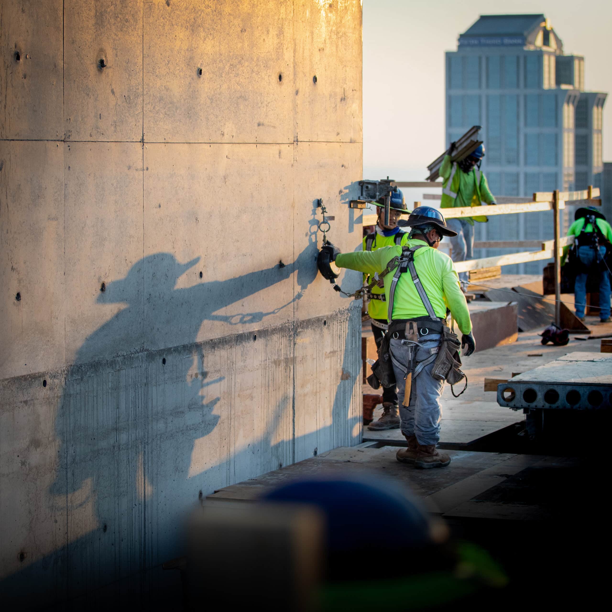 harnessed construction workers on concrete project